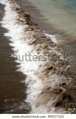 wave on tropical beach sand