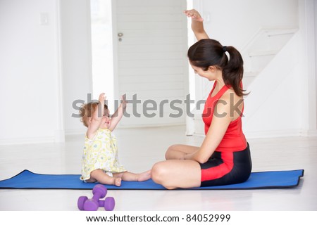 Mother and baby doing yoga Royalty-Free Stock Photo #84052999