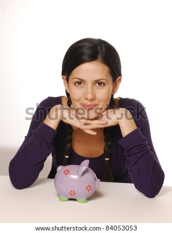 Young woman and piggy bank saving money.
