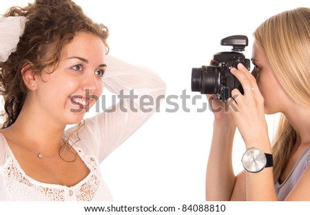 portrait of a two girls taking pictures on a white
