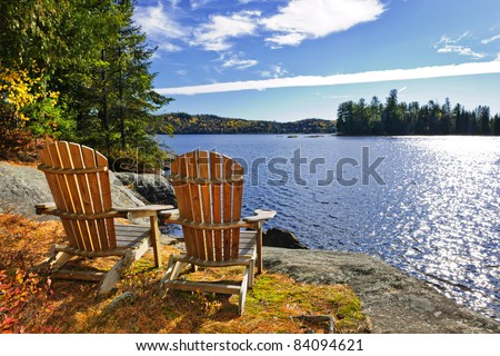 Adirondack chairs at shore of  Lake of Two Rivers, Ontario, Canada Royalty-Free Stock Photo #84094621