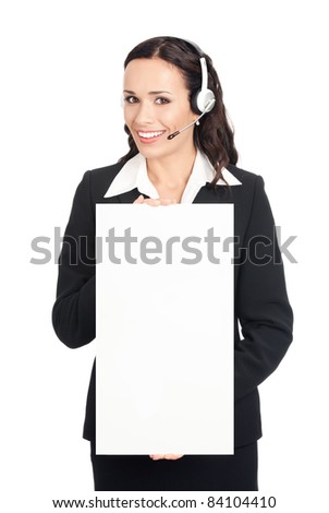 Happy smiling young customer support phone operator in headset showing blank signboard, isolated on white background