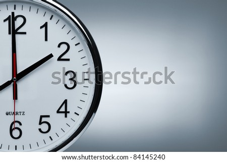 Close up of a clock isolated ob blue background with copy space Royalty-Free Stock Photo #84145240