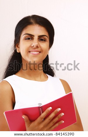 Beautiful female student with a notebook - isolated