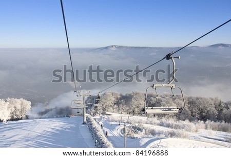 Ski lift chairs and winter landscape