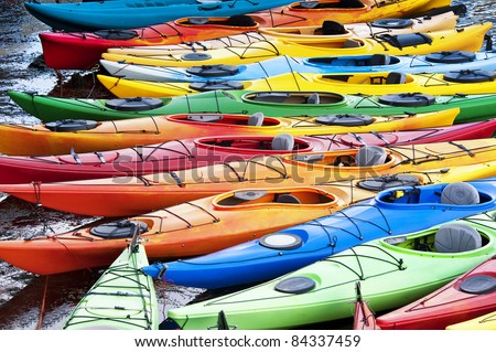 Colorful fiberglass kayaks tethered to a dock as seen from above Royalty-Free Stock Photo #84337459