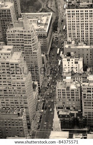 New York City Manhattan street aerial view black and white with skyscrapers, pedestrian and busy traffic.
