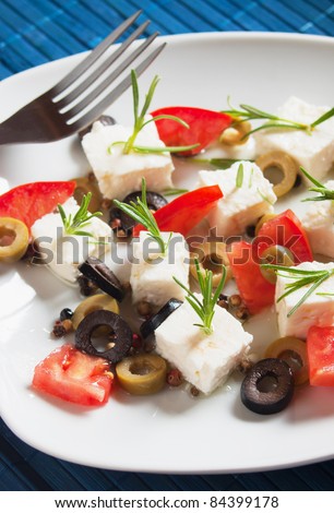 Feta cheese with olive, tomato and rosemary