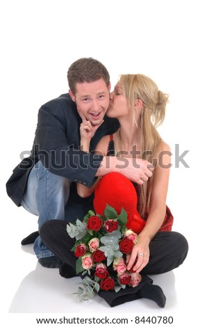 Two casual dressed young adults, teenage man and woman proposing with bouquet of roses. studio shot, reflective surface