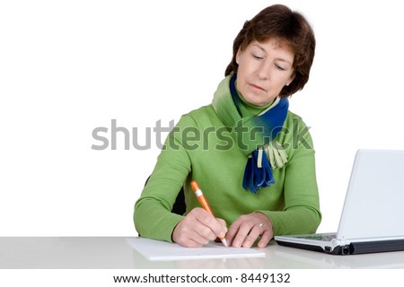 Senior woman with a notebook is writing. Full isolated studio picture