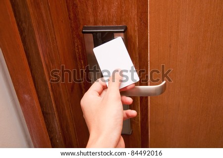 hand touch keycard on hotel door