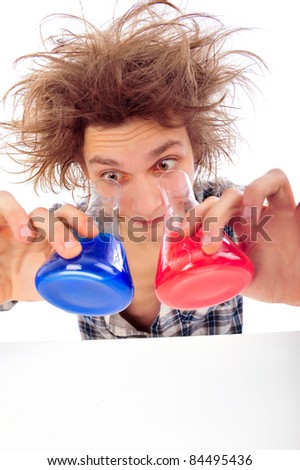 Portrait of funny young man with awesome hairdo isolated on white background. Working with color liquid in different glassware.