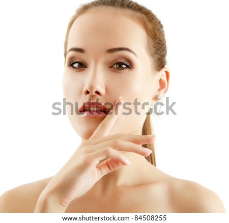 portrait of young beautiful woman with clean skin holding hand close to her face isolated on white background