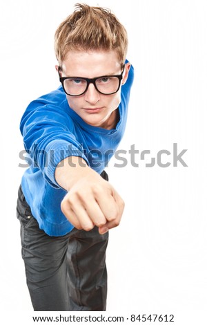 funny young man with glasses standing and looking at camera, isolated over white
