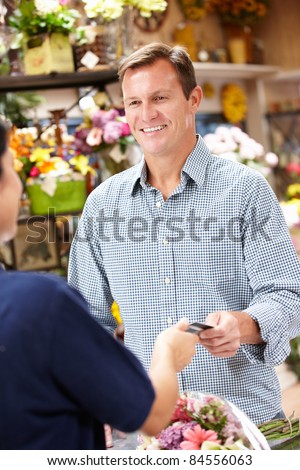 Man standing outside bakery/cafe
