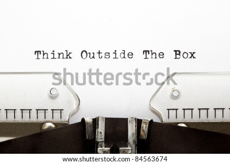 Concept image about unconventional or different thinking. THINK OUTSIDE THE BOX written on an old typewriter .