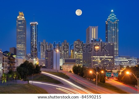 Skyline of downtown Atlanta, Georgia from above Freedom Parkway with a full moon.