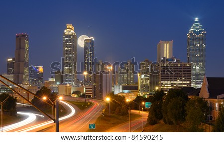 Skyline of downtown Atlanta, Georgia from above Freedom Parkway with a full moon.
