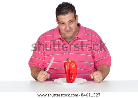 Fat man eating a red pepper isolated on white background