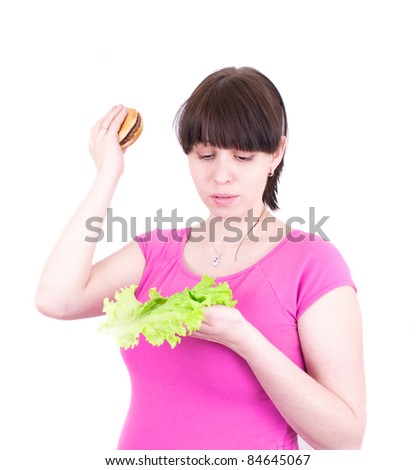 The young woman throws out a hamburger holding salad