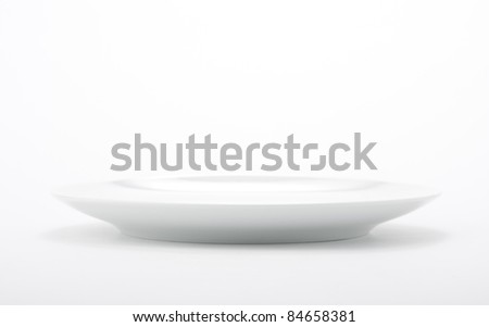 White empty plate on seamless white background.