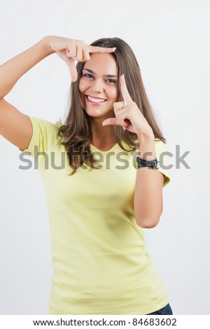 Portrait of young happy smiling business woman framing her face with hands, isolated on white background