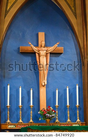 Crucifix above the altar with candles