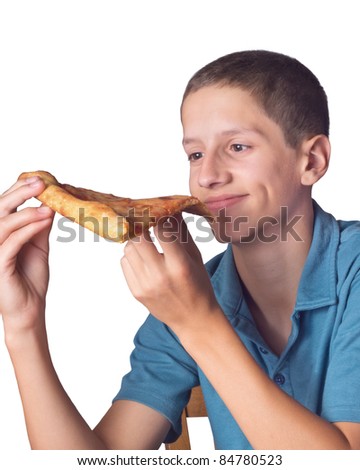Teenage boy looking comically happy to be eating pizza