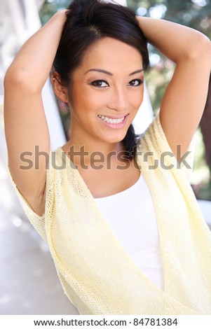 A pretty asian woman happy at home