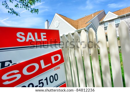 Real estate sold insert on Realtor for sale sign and white picket fence at a selling suburban house after a successful resale brokerage transaction in the residential multiple listing service