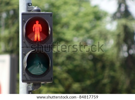 Traffic light with red sign for walkers to stop in urban ambiance