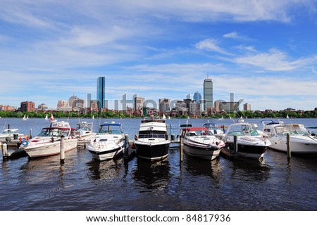 Boston Charles River with urban city skyline skyscrapers and boats with blue skyr.