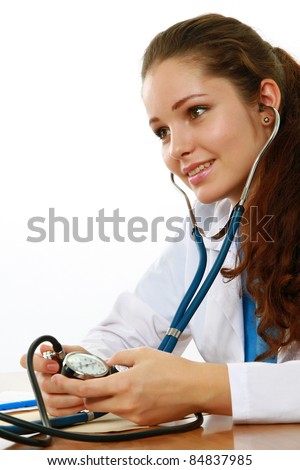 Young female doctor writing something isolated