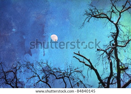 background picture with skeletal trees with snow on their branches against the night sky with moon and watercolor paper for texture