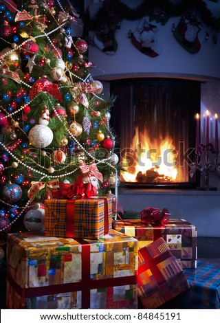 Christmas Tree and Christmas gift boxes in the interior with a fireplace