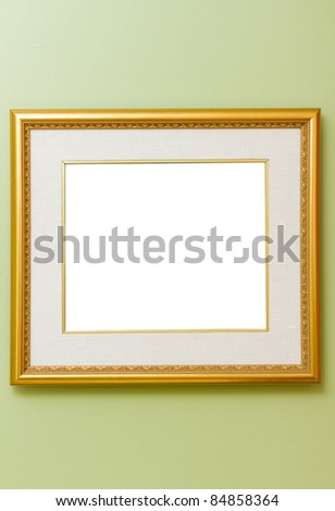Gold wood frame on green wall