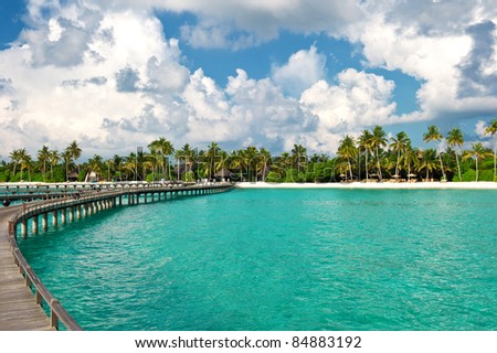 view of tropical island beach with beautiful blue cloudy sky