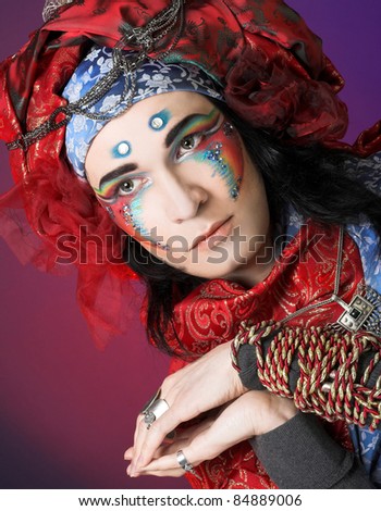 Young woman in creative image and with face-art