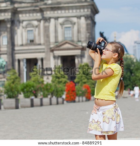 young girl with photo camera. Berlin background