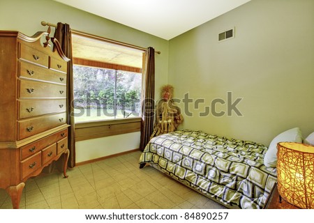 Kids bedroom with small bed and dresser.