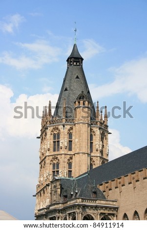 Detailed view of an imposing bell tower, blue sky in background