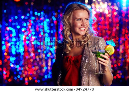 Image of happy girl holding cocktail at party