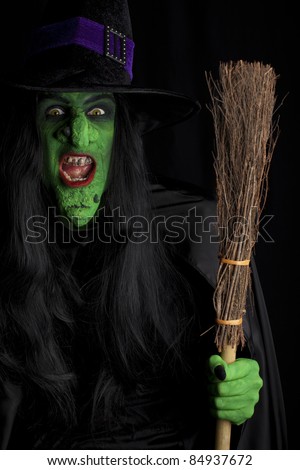 Evil and her broomstick, black background