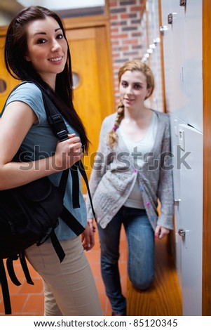 Young students standing up in a corridor