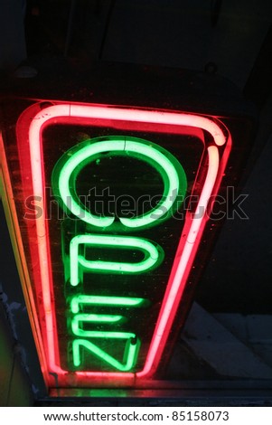 A neon open sign at night.