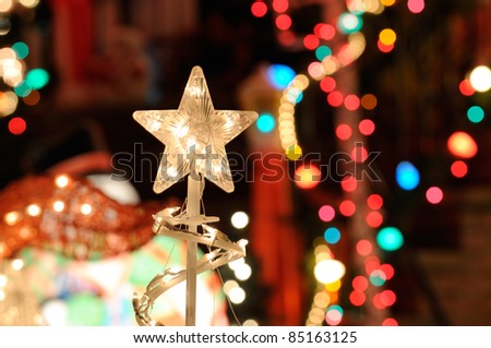 Christmas Lights Background. Nativity star, blurred lights and outdoor decorations