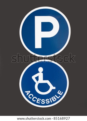 Blue Signs for Parking for Handicapped People on Grey Background