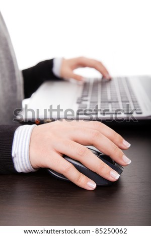 Close-up of female hand on mouse while working on laptop