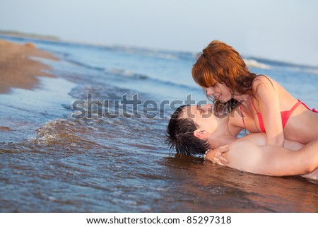 young adult happy couple couple laying water