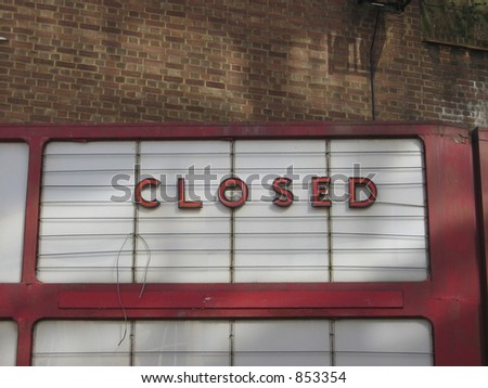 Dilapidated old style 'CLOSED' signage on a disused cinema.